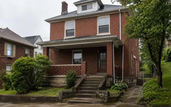 Brick Pittsburgh house and wet sidewalk after rainfall